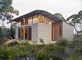 Ridge-top retreats in South Australia's Deep Creek Conservation Park have been built using COLORBOND® steel in the colour Birch for the curved roof and the front and side wall cladding to minimise the impact on the surrounding environment.