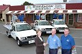 BHP Steel ' s Diane Bass congratulates John Harvey (centre) and Mark Humphries from Sunbow Roofing, winners of the ZINCALUME® steel Toyota HiLux promotion. 